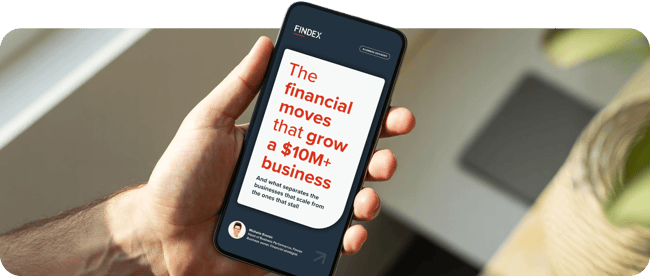 Person holding a smartphone displaying the Findex Business Performance Guide, "The financial moves that grow a $10M+ Australian business Person holding a smartphone displaying the Findex Business Performance Guide, "The financial moves that grow a $10M+ Australian business